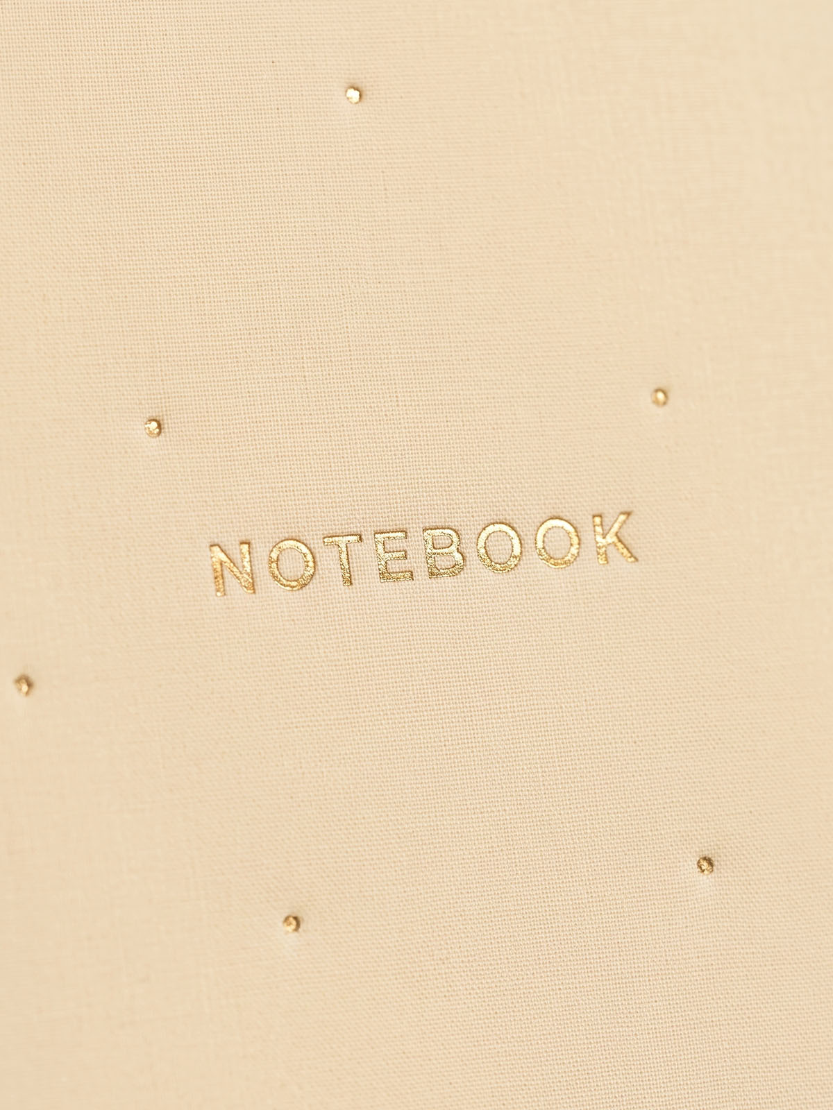 detalle dorado de cuaderno color mantequilla